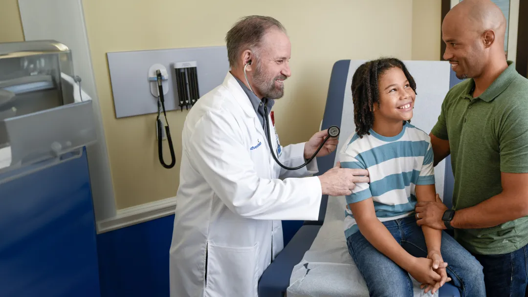 Centra Care Provider Check's a Child Patient's Breathing