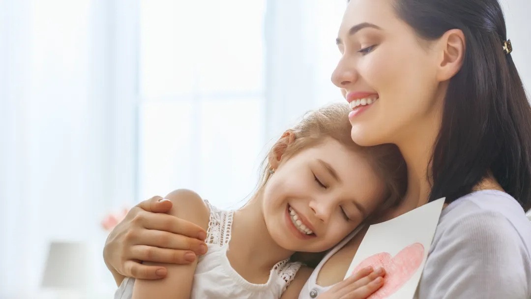 Mother and daughter share a loving hug