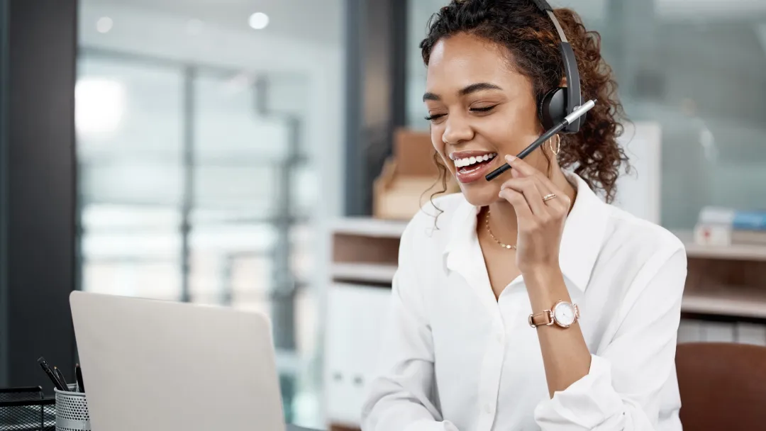 Female Professional using a laptop and headset