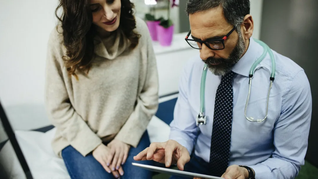 Woman discussing treatment with doctor