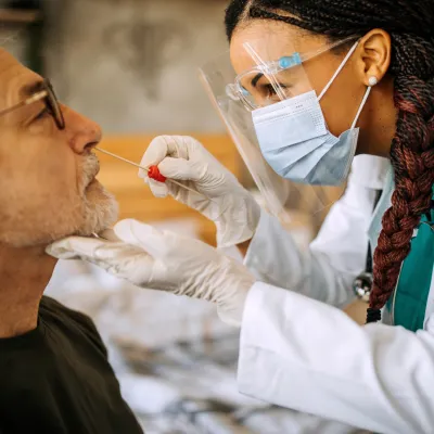 A Provider Swabs a Man's Nose for Testing Purposes