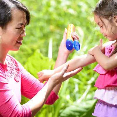 Applying sunscreen to child