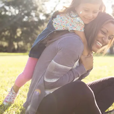 Daughter climbing on her Mother
