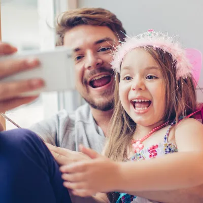 A father and daughter stay connected with a video call.