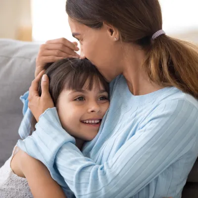 A mother hugs her child.
