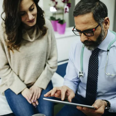Woman discussing treatment with doctor
