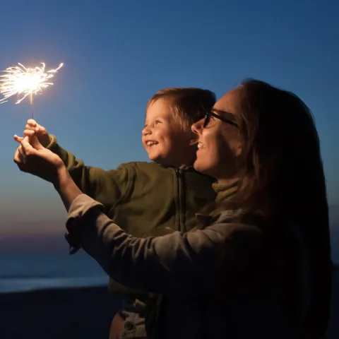 Kid holding a sparkler 