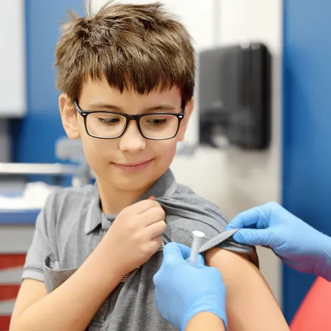 A Boy About to Get a Tetanus Shot in His Bicep 