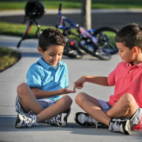 Kids Playing on Sidewalk with Bikes