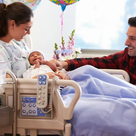 A joyful family welcomes a new baby.