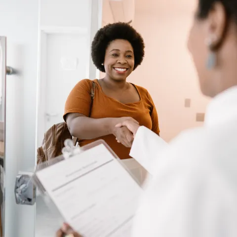 Woman shaking her doctor's hand.