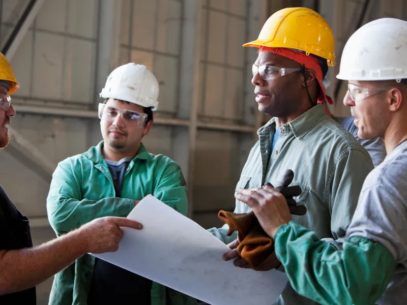 Workers discussing plans