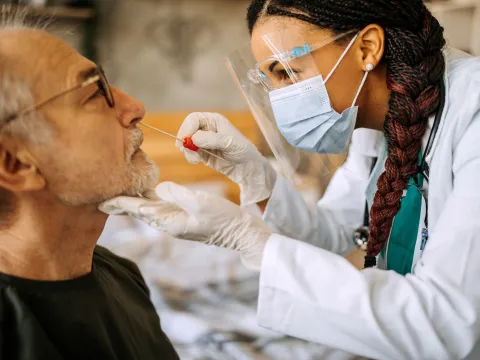 A Provider Swabs a Man's Nose for Testing Purposes
