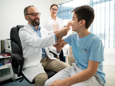 Two Physicians Before a Sports Physical on a Teenage Boy