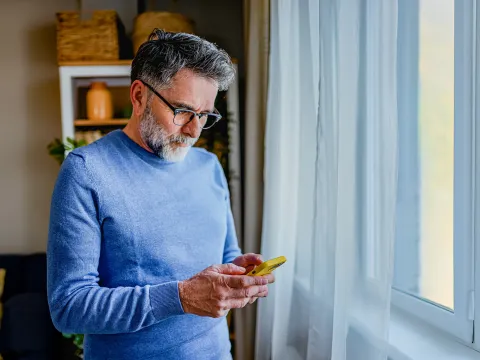 Man looking down at phone
