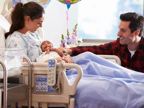 A joyful family welcomes a new baby.