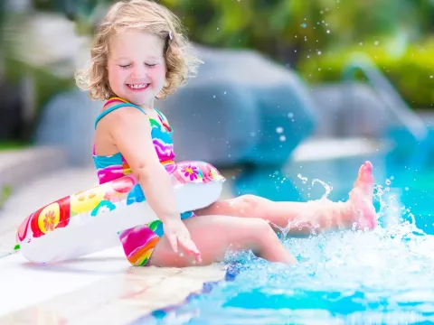 Little girl swimming in pool